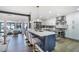 Open kitchen boasts stainless steel appliances, island with seating, and modern finishes at 3911 Kamden Way, Las Vegas, NV 89119