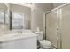 Well-lit bathroom with white cabinets, shower and toilet at 4130 Lucas Ave, Las Vegas, NV 89120