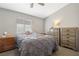 Comfortable bedroom with a large bed, ceiling fan, and dresser at 4130 Lucas Ave, Las Vegas, NV 89120