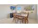 Dining room with a window view, sliding door access to the backyard, and tile flooring at 4130 Lucas Ave, Las Vegas, NV 89120
