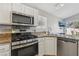 Stainless steel appliances in a kitchen with granite countertops and a breakfast nook at 4130 Lucas Ave, Las Vegas, NV 89120
