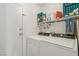 Functional laundry area with washer, dryer, and shelving for storage at 4130 Lucas Ave, Las Vegas, NV 89120