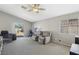 Spacious living room with two recliner chairs, ceiling fan, and slider door to backyard at 4130 Lucas Ave, Las Vegas, NV 89120