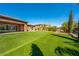 Spacious backyard features an artificial lawn, and direct access to the home's covered patio at 47 Grand Masters Dr, Las Vegas, NV 89141