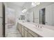 Spacious bathroom with double vanity and views into the bedroom at 47 Grand Masters Dr, Las Vegas, NV 89141