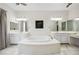 Bathroom features a soaking tub, double vanity, marble floors, and a stylish modern design at 47 Grand Masters Dr, Las Vegas, NV 89141