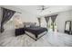 Bright bedroom features marble floors, a ceiling fan, and a large window with plantation shutters at 47 Grand Masters Dr, Las Vegas, NV 89141