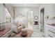 Well-lit Bedroom with crib, seating, and view to the bathroom at 47 Grand Masters Dr, Las Vegas, NV 89141