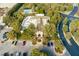Elegant clubhouse with arched entrance, palm trees, and well-manicured landscaping surrounded by lush greenery at 47 Grand Masters Dr, Las Vegas, NV 89141
