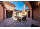 Inviting courtyard featuring an outdoor fireplace, stylish seating, and string lights at 47 Grand Masters Dr, Las Vegas, NV 89141