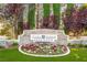 Stone entrance sign for Southern Highlands Golf Club, surrounded by colorful flowers and manicured landscaping at 47 Grand Masters Dr, Las Vegas, NV 89141