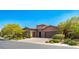 Beautiful single-story home featuring lush landscaping, a paver driveway, and a three-car garage at 47 Grand Masters Dr, Las Vegas, NV 89141