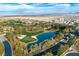 Scenic aerial view of a lush golf course with a beautiful lake and manicured greens surrounded by trees at 47 Grand Masters Dr, Las Vegas, NV 89141