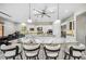 Kitchen island with marble countertop, barstools, and views of the kitchen, dining and outdoor spaces at 47 Grand Masters Dr, Las Vegas, NV 89141