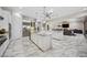 Spacious kitchen featuring double islands, marble floors, white cabinets, and stainless steel appliances at 47 Grand Masters Dr, Las Vegas, NV 89141