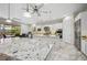 Modern kitchen with stainless steel appliances, marble countertops, white cabinetry, and a connecting dining area at 47 Grand Masters Dr, Las Vegas, NV 89141