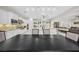 Expansive open kitchen with island, dining area, stainless steel appliances, and seamless flow to living space at 47 Grand Masters Dr, Las Vegas, NV 89141