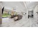 Open-concept living room with ample natural light, tile floors, and kitchen access at 47 Grand Masters Dr, Las Vegas, NV 89141