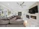 Bright living room with modern fireplace, large sectional, and open access to kitchen and dining at 47 Grand Masters Dr, Las Vegas, NV 89141