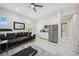 Open-concept living room with modern decor, adjacent to a sleek kitchen at 47 Grand Masters Dr, Las Vegas, NV 89141