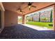 Covered patio overlooking a landscaped backyard with stone wall at 47 Grand Masters Dr, Las Vegas, NV 89141