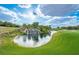 Picturesque pond with a cascading waterfall on a sunny day, near the golf course at 47 Grand Masters Dr, Las Vegas, NV 89141