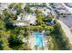 Aerial view of a sparkling pool and spa surrounded by palm trees and lounge chairs at 47 Grand Masters Dr, Las Vegas, NV 89141