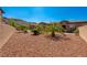 Landscaped side yard showcasing desert-style rock ground cover, and verdant plants for tranquil curb appeal at 47 Grand Masters Dr, Las Vegas, NV 89141
