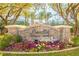 Sandlin Tennis Center entrance with flowerbeds and a stone sign under palm trees at 47 Grand Masters Dr, Las Vegas, NV 89141