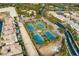 Aerial view of the community tennis courts, showcasing their layout amid lush landscaping and surrounding residences at 47 Grand Masters Dr, Las Vegas, NV 89141