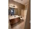 Bathroom features a vanity with ample counter space, a large mirror, and a shower-tub combination at 4824 Quartz Crest St, North Las Vegas, NV 89081