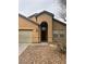 Inviting home exterior with neutral tones, desert landscaping, and a charming, covered entryway at 4824 Quartz Crest St, North Las Vegas, NV 89081