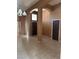 Open-concept living room with high ceilings, tile flooring, and neutral wall color at 4824 Quartz Crest St, North Las Vegas, NV 89081