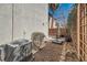 A home's siding is seen next to an air conditioner and a shady patio with metal furniture at 517 Primrose Hill Ave, Las Vegas, NV 89178
