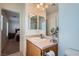 A well-lit bathroom offers a vanity, mirror, and is located next to the primary bedroom at 517 Primrose Hill Ave, Las Vegas, NV 89178