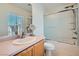 Bright bathroom featuring a vanity, framed mirror, toilet and a shower/bathtub combo at 517 Primrose Hill Ave, Las Vegas, NV 89178