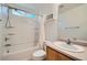 Bathroom featuring a shower-tub combo, a toilet, and a sink with wooden cabinetry at 517 Primrose Hill Ave, Las Vegas, NV 89178