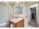 Bright bathroom featuring a wood vanity, mirror and a shower-tub combo at 517 Primrose Hill Ave, Las Vegas, NV 89178