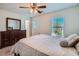 This bright bedroom includes a comfortable bed, dresser, and a large window with horizontal blinds at 517 Primrose Hill Ave, Las Vegas, NV 89178