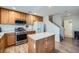 Well-lit kitchen featuring stainless steel appliances, wood cabinets, and a functional center island at 517 Primrose Hill Ave, Las Vegas, NV 89178