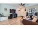 Comfortable living room featuring wood floors, ample natural light, and a modern entertainment center at 517 Primrose Hill Ave, Las Vegas, NV 89178