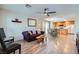 Bright and open living room featuring wood floors, a ceiling fan, and a combined dining area at 517 Primrose Hill Ave, Las Vegas, NV 89178