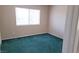 An interior shot of a bedroom with verdant carpeting and a window letting in ample sunlight at 530 Sellers Pl, Henderson, NV 89011