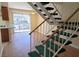 An open living space, showing stairs, wood flooring, and a sliding door to the outside at 530 Sellers Pl, Henderson, NV 89011