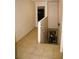 Hallway leading to the basement area with beige tile flooring and white handrail along the staircase at 5381 Awbury Ave, Las Vegas, NV 89110