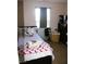Comfortable bedroom with natural light, a black bedframe, and a dresser for ample storage at 5381 Awbury Ave, Las Vegas, NV 89110