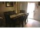 Traditional dining room features a wood table with seating for eight and sliding glass doors to the exterior at 5381 Awbury Ave, Las Vegas, NV 89110