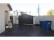 Gated driveway, providing privacy and security, with blue trash bins on the side of the home at 5381 Awbury Ave, Las Vegas, NV 89110