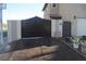 Elegant gated entrance providing privacy, featuring a pedestrian gate, and complemented by decorative planters at 5381 Awbury Ave, Las Vegas, NV 89110