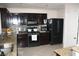 Contemporary kitchen with dark cabinetry, granite countertops, tile backsplash, and modern appliances at 5381 Awbury Ave, Las Vegas, NV 89110
